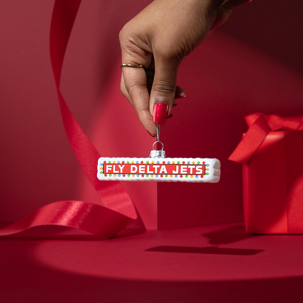 Add a flare of Delta history to your tree with our glass, Festive Fly Delta Jets ornament. Inspired by the sign that has welcomed travelers to and from Atlanta for over 50 years.