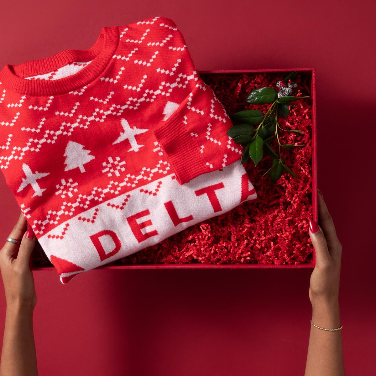 Show off your love for travel this winter with our Red Delta Holiday Sweater. Cozy and colorful, this sweater is perfect for any festive occasion. 