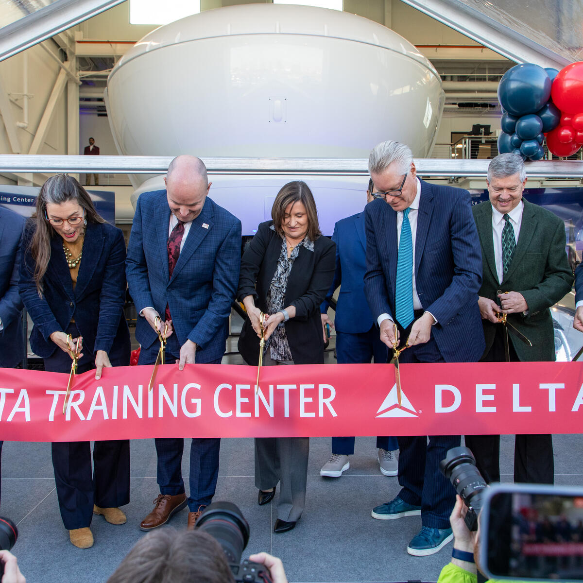 Delta leaders and Salt Lake City government officials cut the ribbon at the opening ceremony at Delta's new pilot training facility