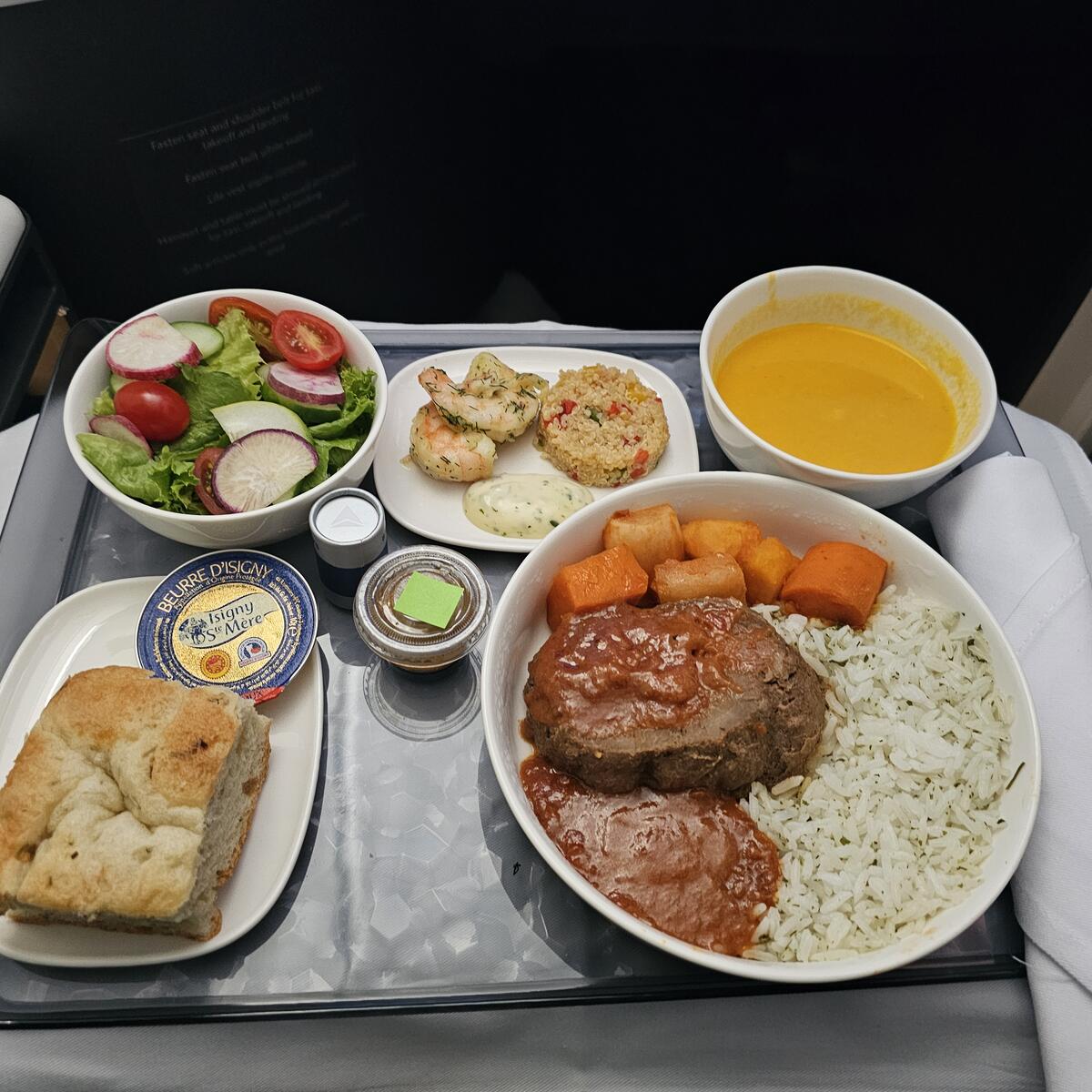 Braised beef with domoda sauce, steamed rice and roasted root vegetables.