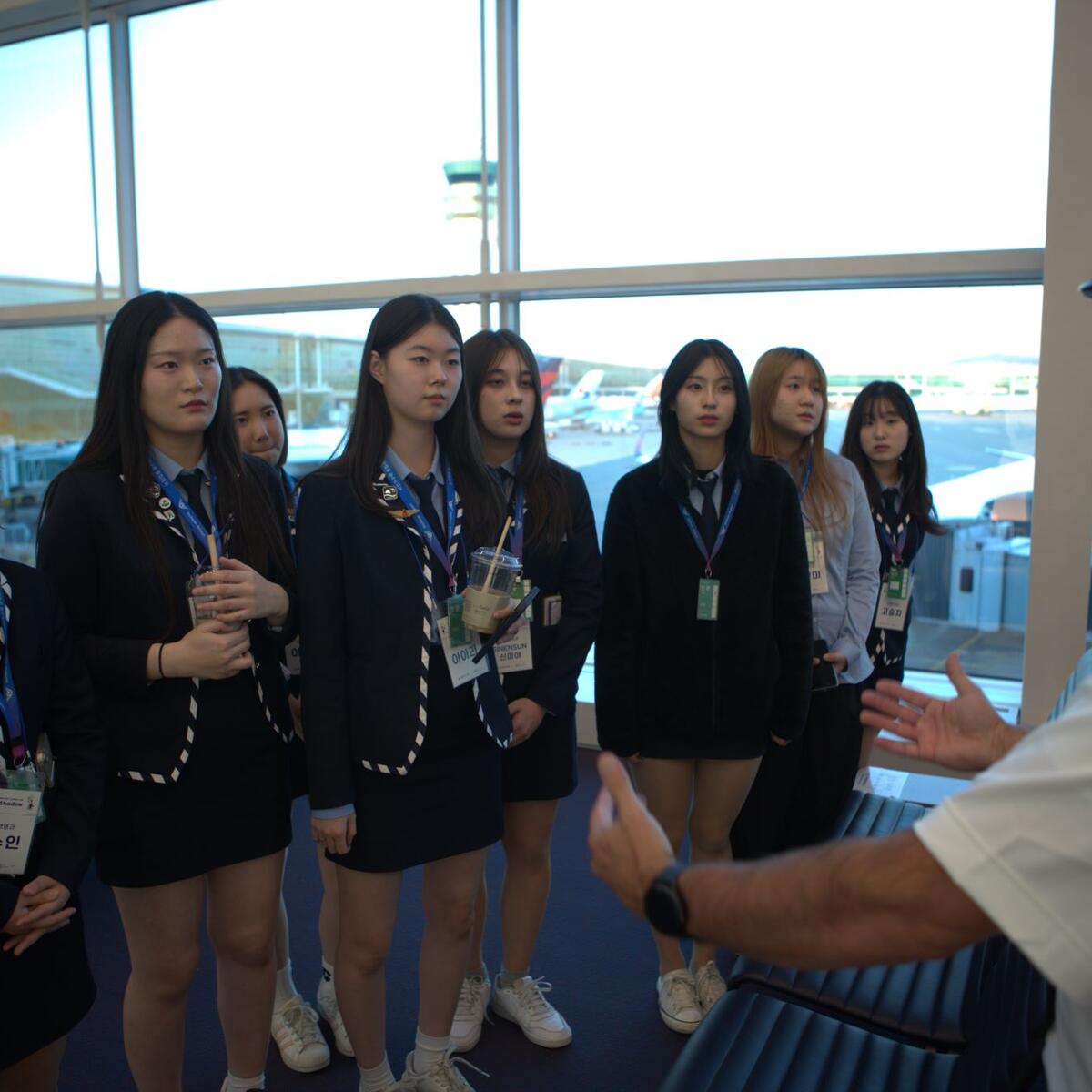 High school students hear from a Delta pilot at ICN Airport during their job shadowing experience with Delta and Junior Achievement.