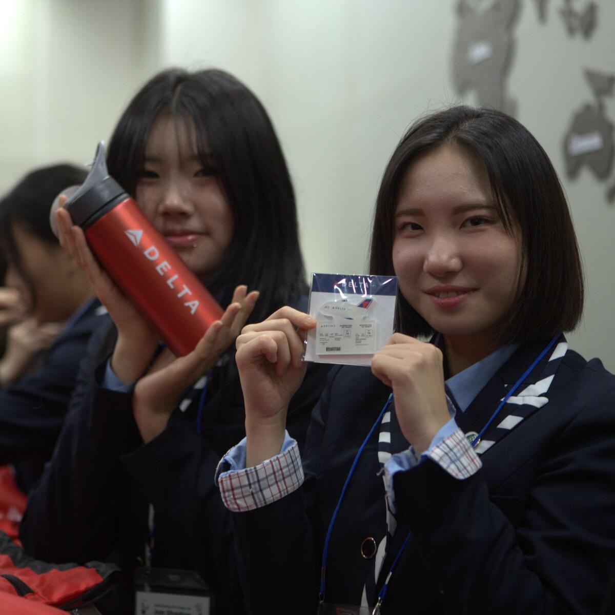 High school students enjoy their Delta-branded merch at ICN Airport during their job shadowing experience with Delta and Junior Achievement.