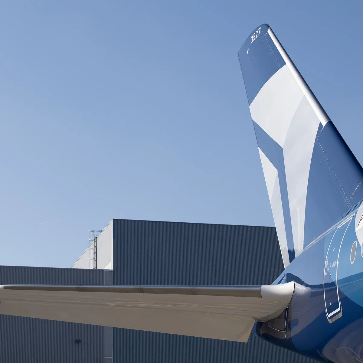 A detail shot of Delta's Centennial livery, featuring swooping designs and Delta's Centennial colors: blue and silver.