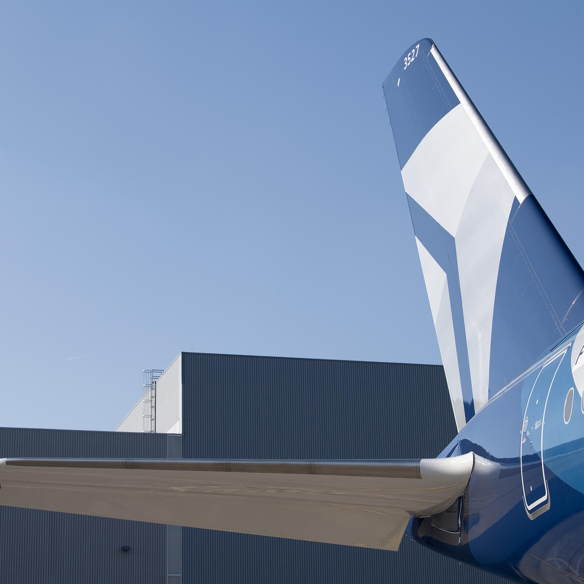 A detail shot of Delta's Centennial livery, featuring swooping designs and Delta's Centennial colors: blue and silver.