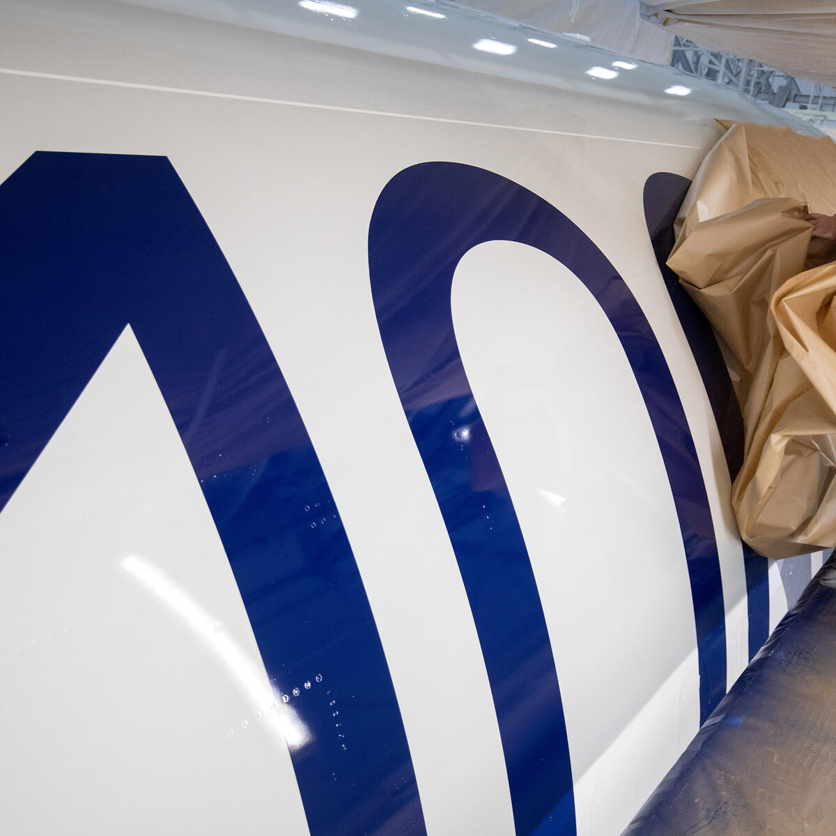 A bold 100 emblem is unmasked for Delta's Centennial livery.