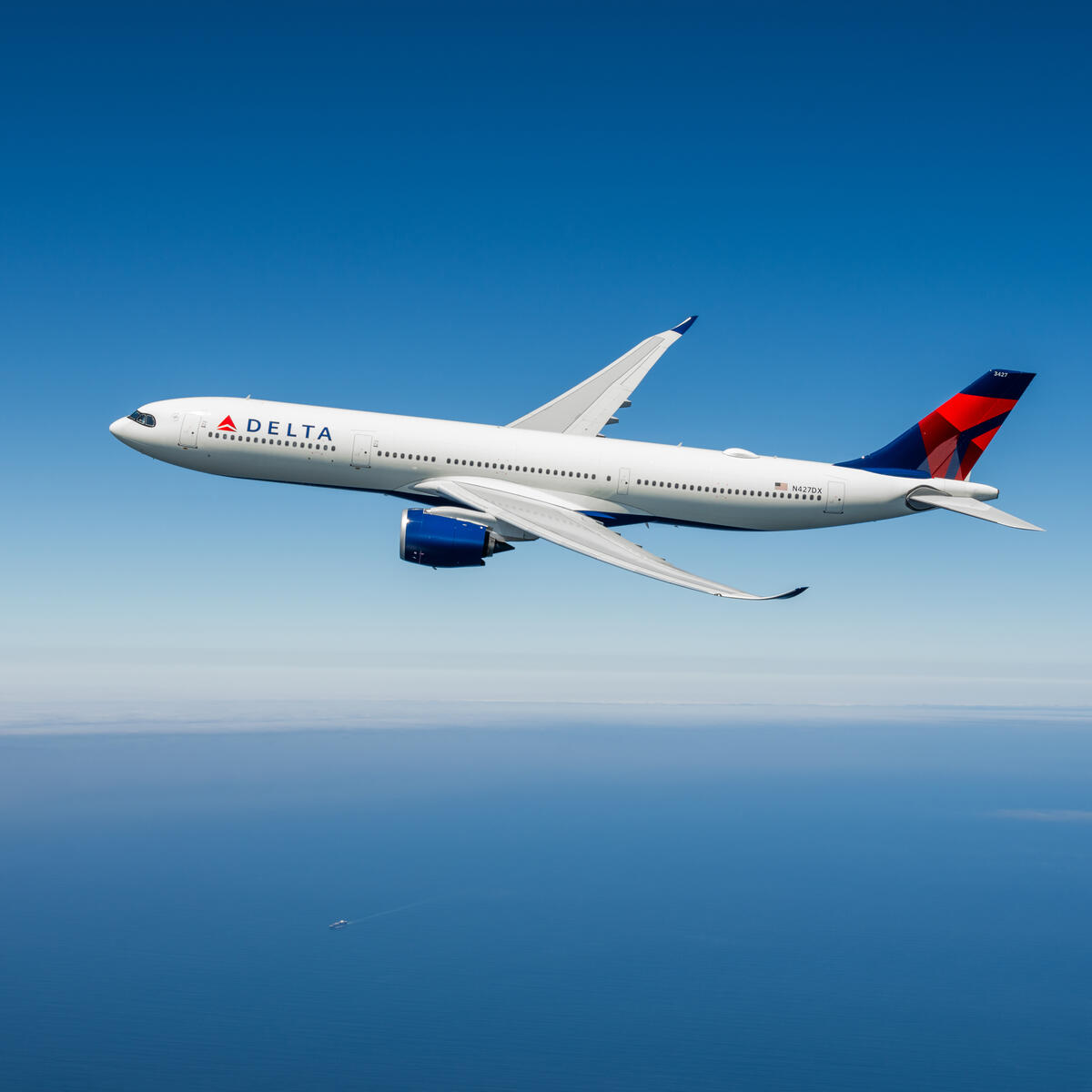 An Airbus A330-900neo in flight against a blue sky