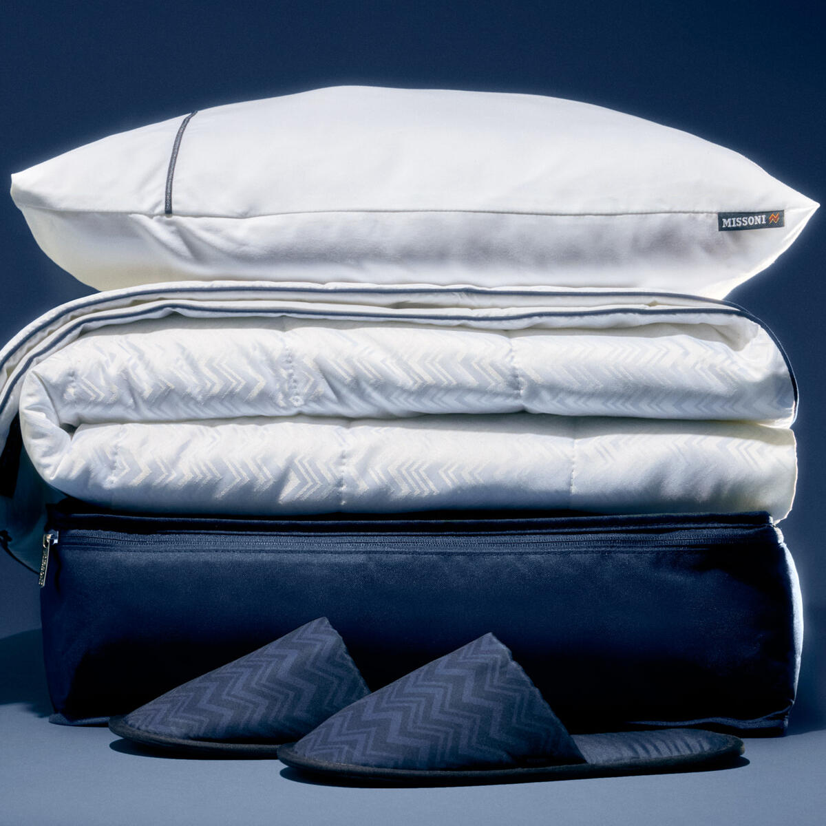 A stack of Delta's new Delta One bedding, created in partnership with Missoni