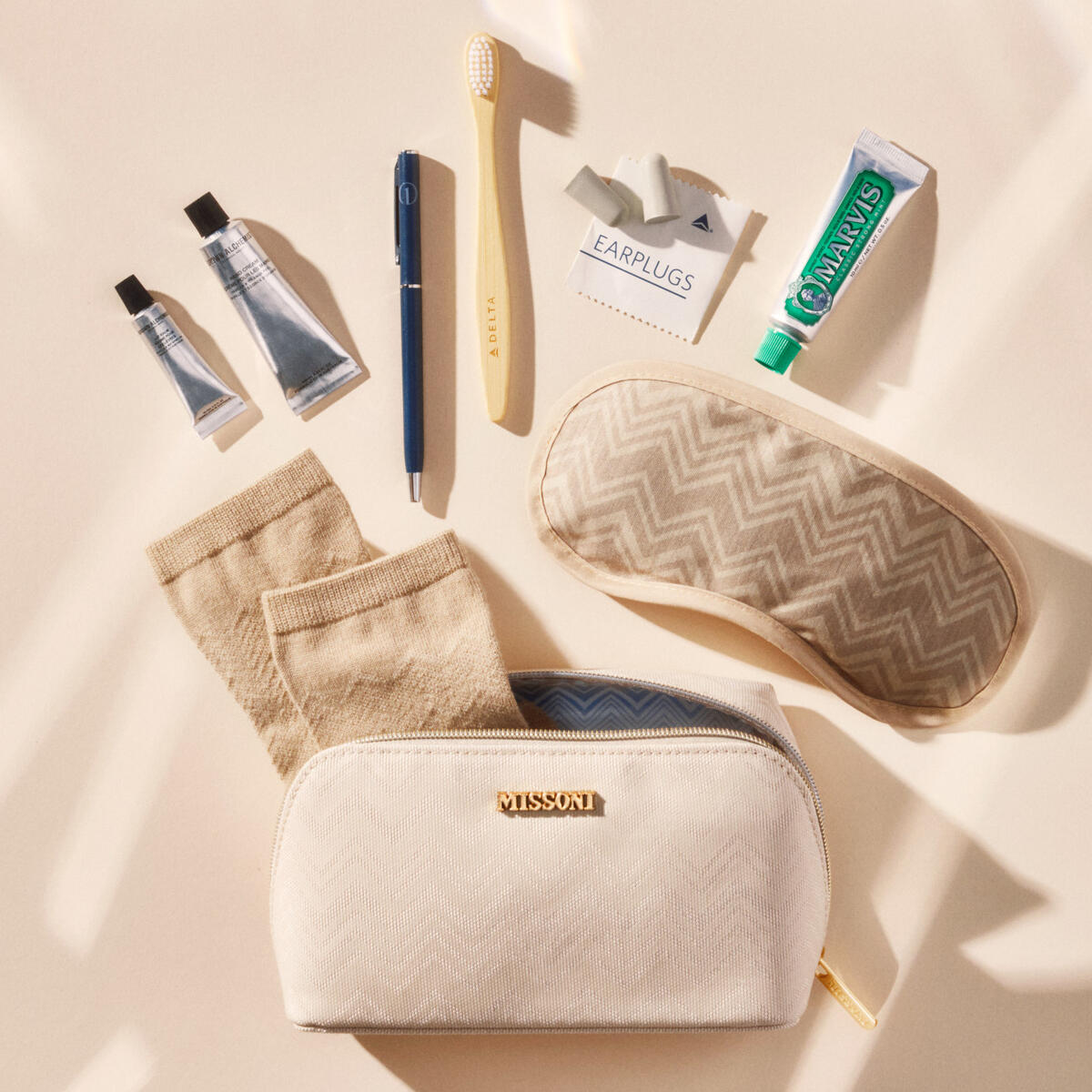 A shot featuring the new Delta One x Missoni amenity kit and the products featured inside the kit, which includes Missoni socks, Grown Alchemist skincare and more.