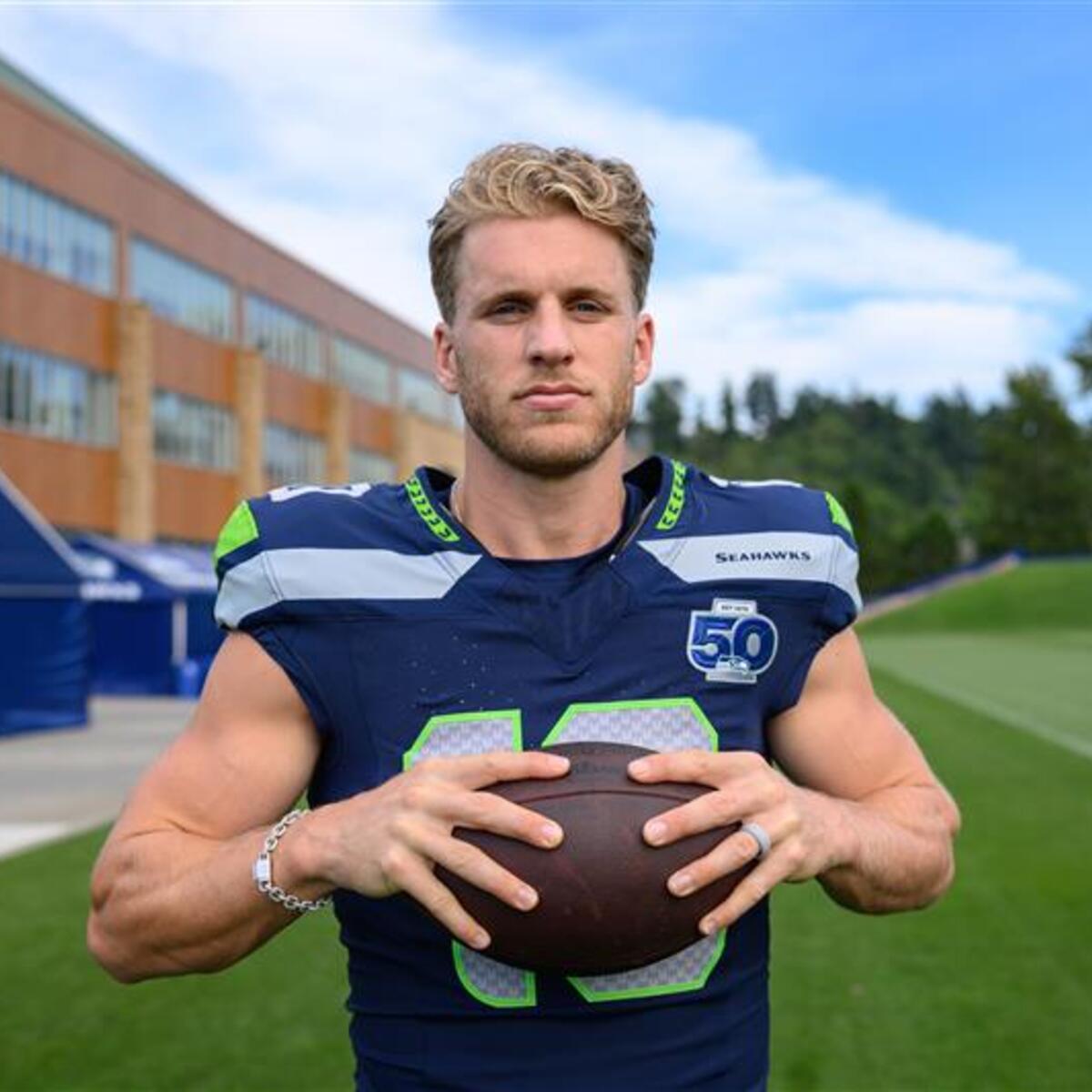 Seattle Seahawks football posing with a football in hands