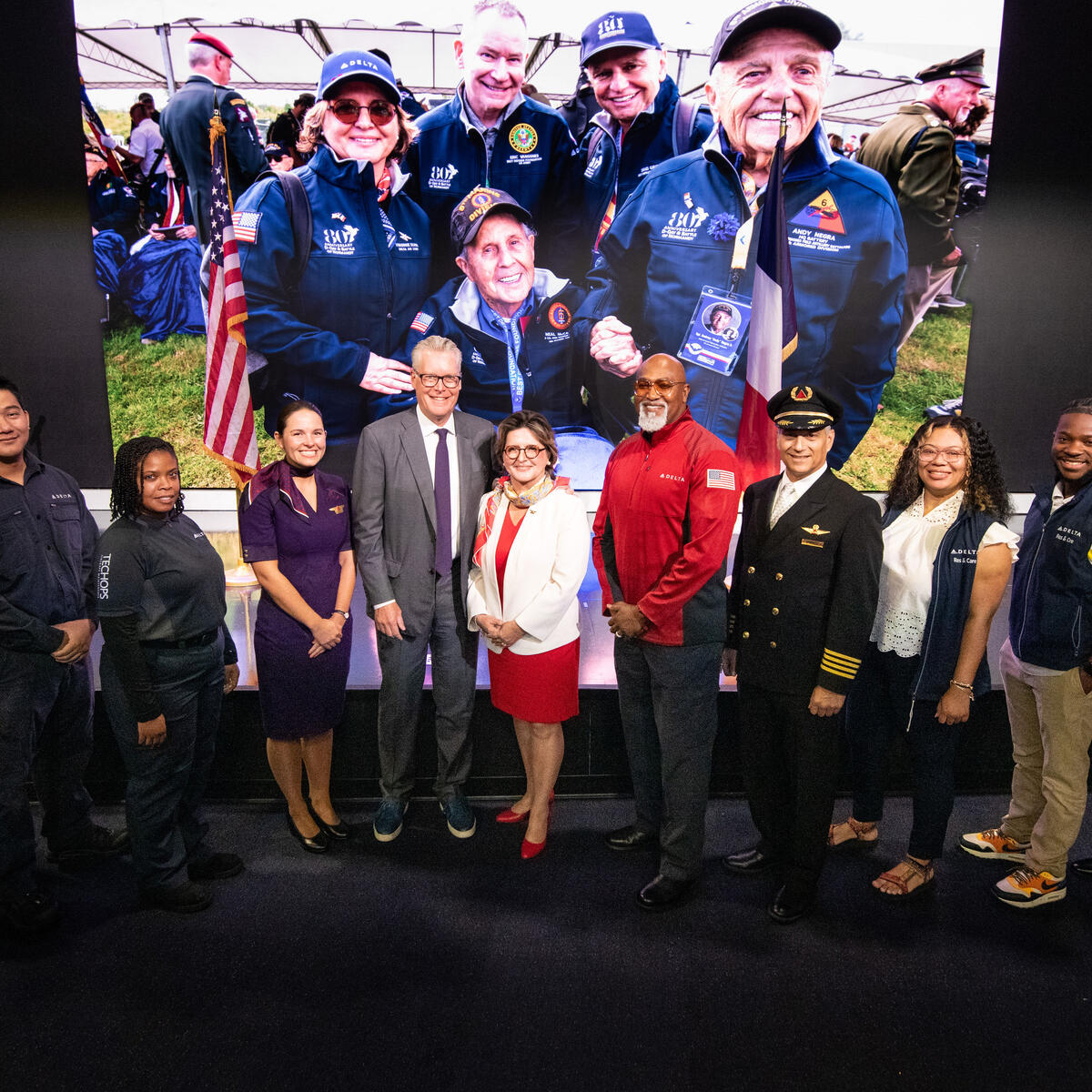 Group photo of Virginie Durr, Ed Bastian and other Delta employees.