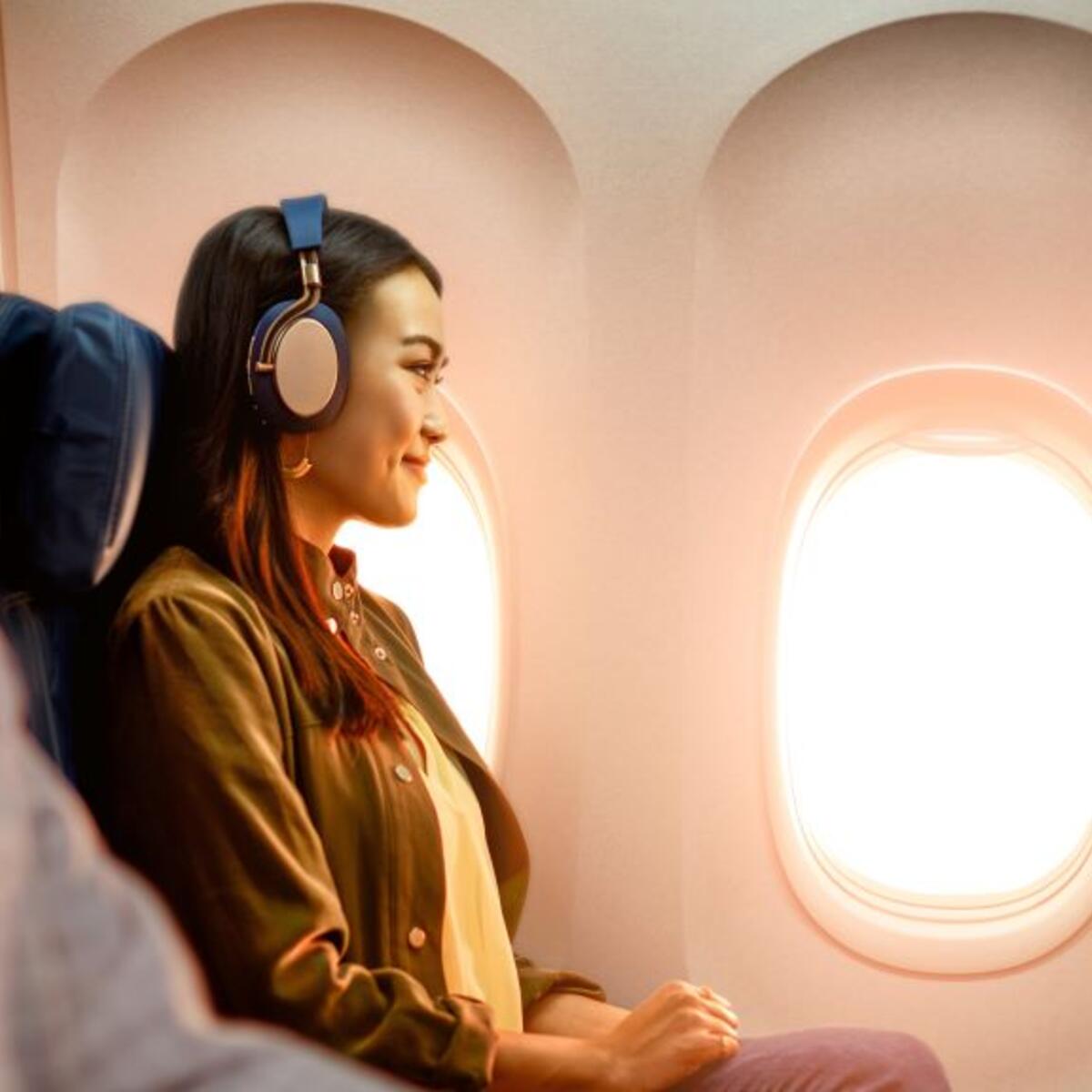 A woman enjoys In-Flight Entertainment onboard a Delta flight.