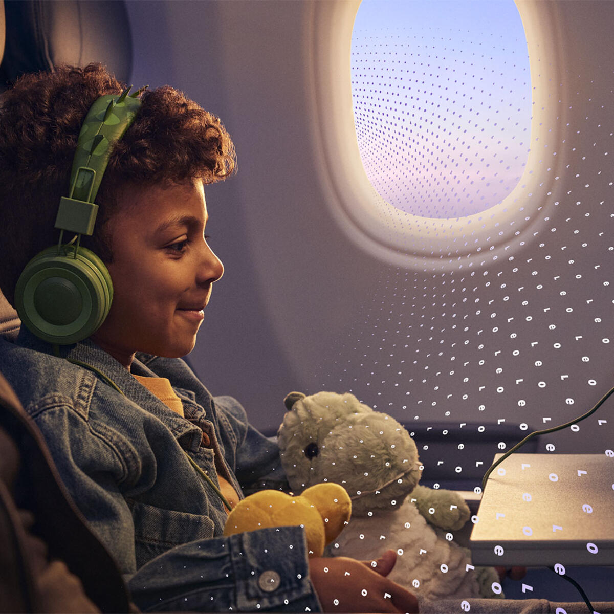  A child seated on an airplane uses a tablet while wearing headphones and holding a stuffed toy, with another seated adult and an airplane window visible, overlaid with a subtle digital pattern.