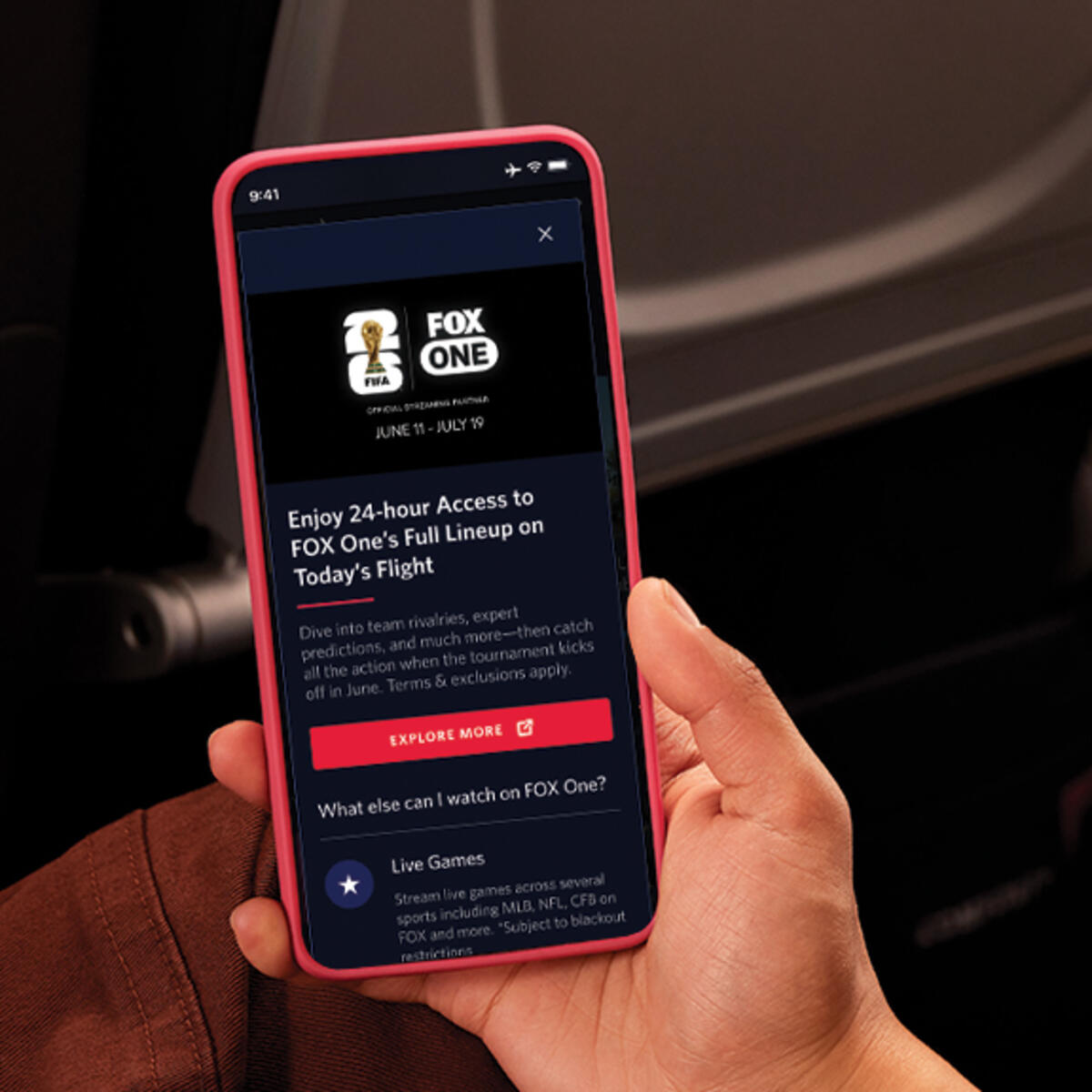 Passenger viewing FOX One content on a smartphone during a flight.