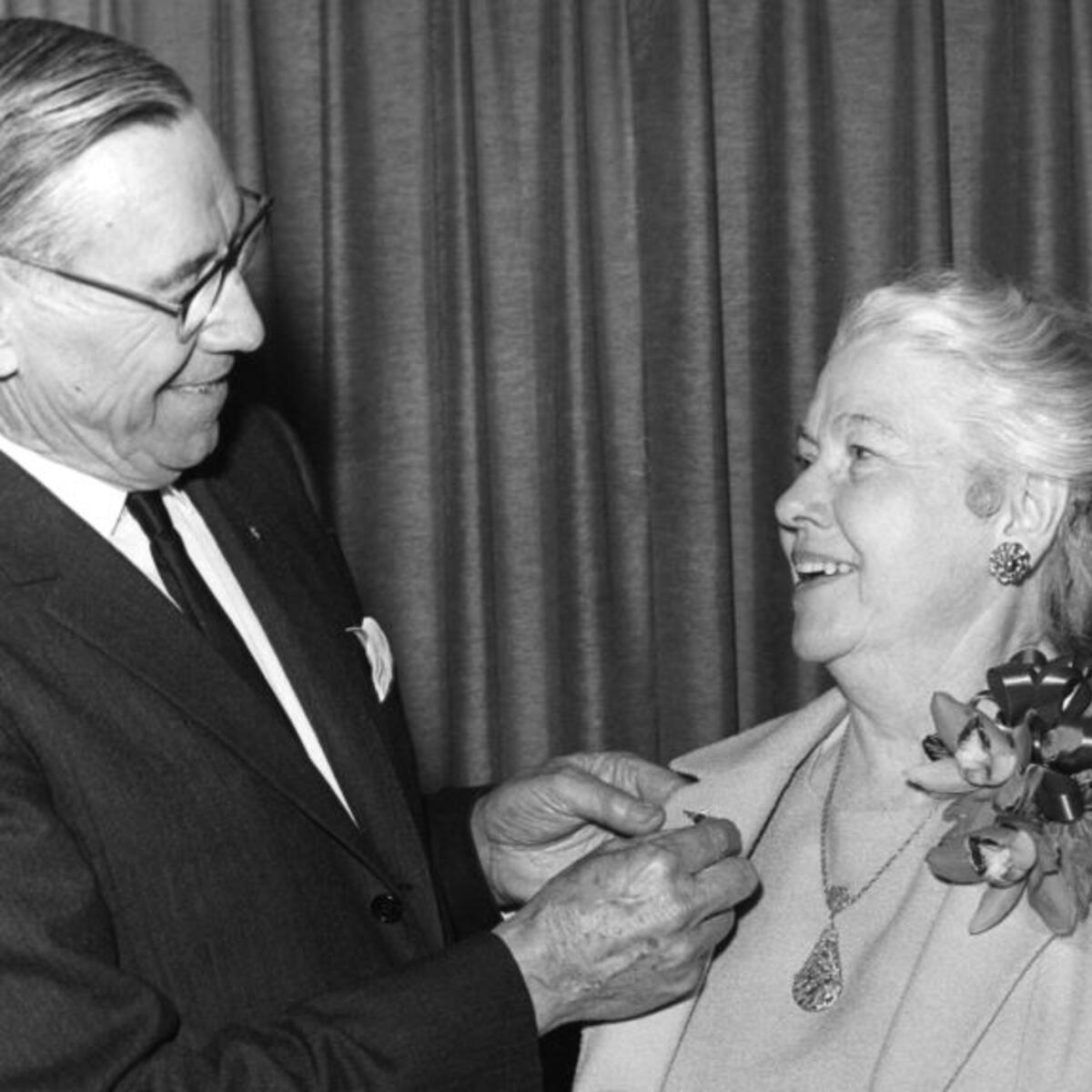 C.E. Woolman presents Catherine FitzGerald with a service pin in 1966, commemorating her 40-year aviation career.