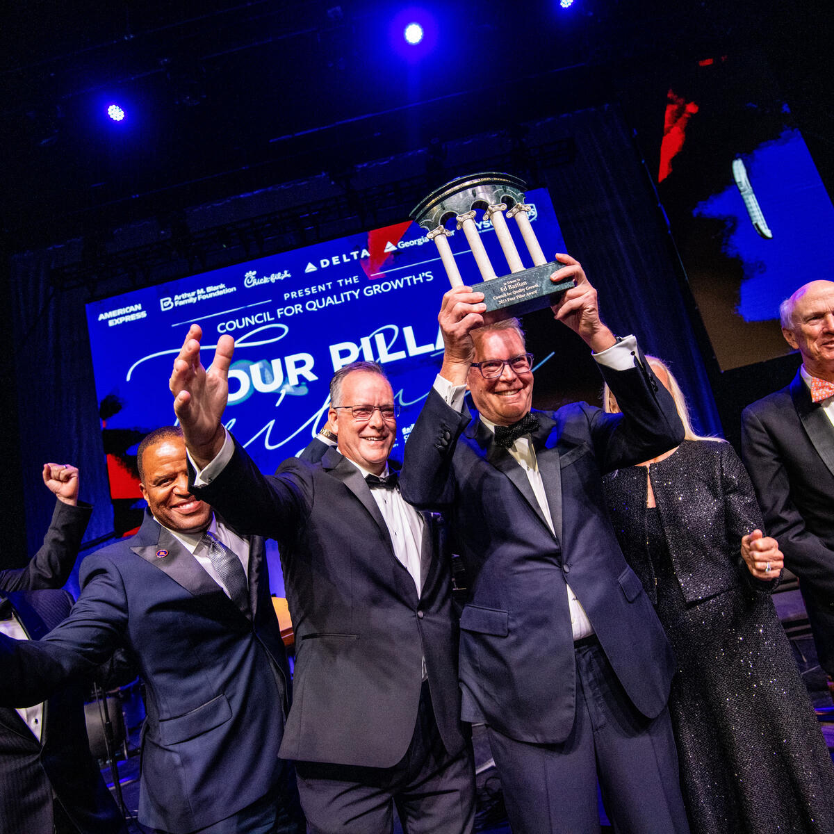 A group shot, with CEO Ed Bastian holding up his Four Pillar Award
