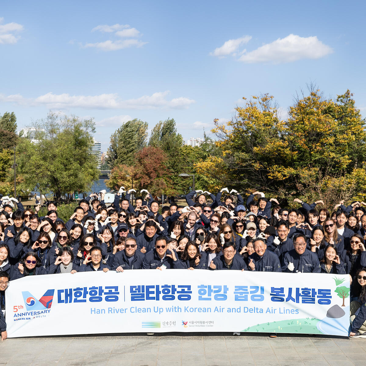 A group poses for a photo after Delta and Korean Air employees volunteered at a Han River cleanup event in Seoul’s Yeouido district to celebrate the fifth anniversary of the two airlines’ trans-Pacific joint venture. 