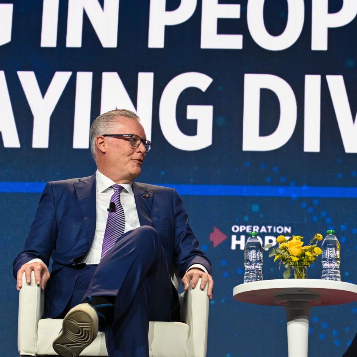 Delta CEO Ed Bastian (left) speaks at the HOPE Global Forum.