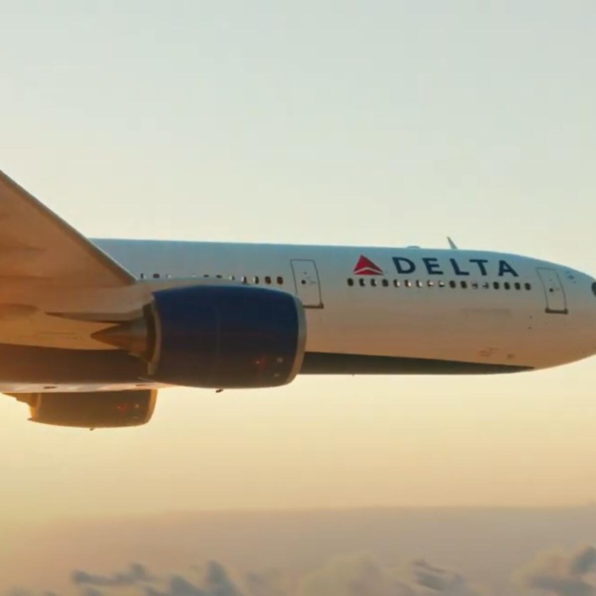 A still of a Delta plane flying against a sunset for Delta's "To See Beyond, Go Up" South America marketing campaign