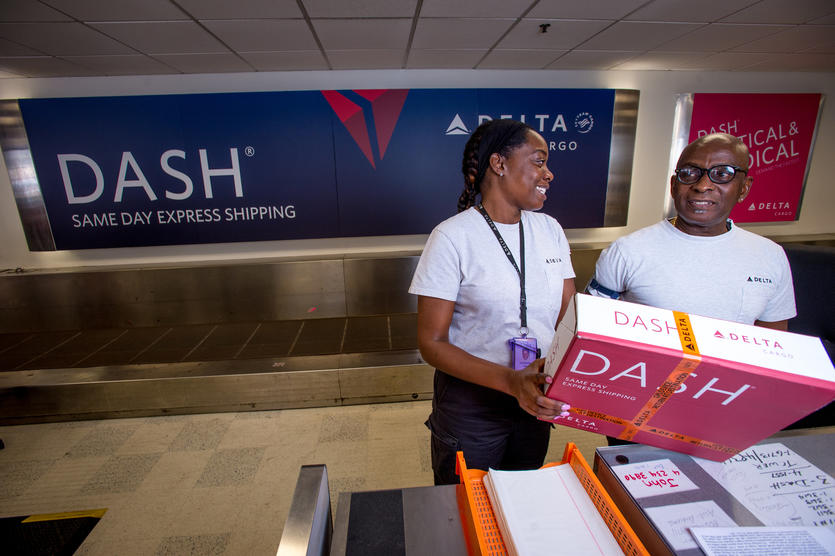 Delta DASH employees with pink package