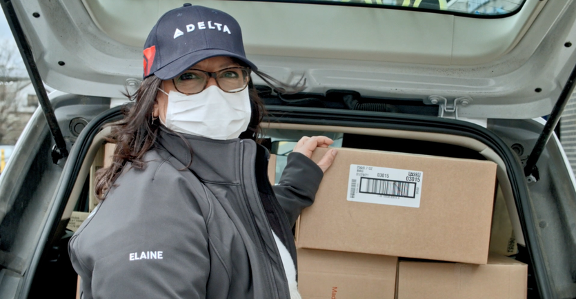 Delta employee donating items to charities