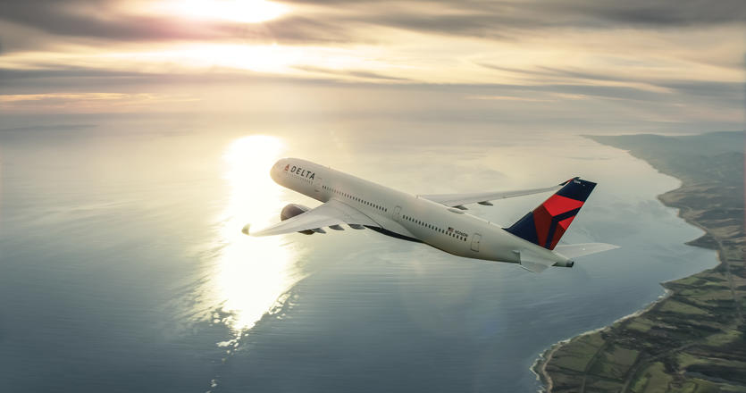 Delta plane flying over water and land
