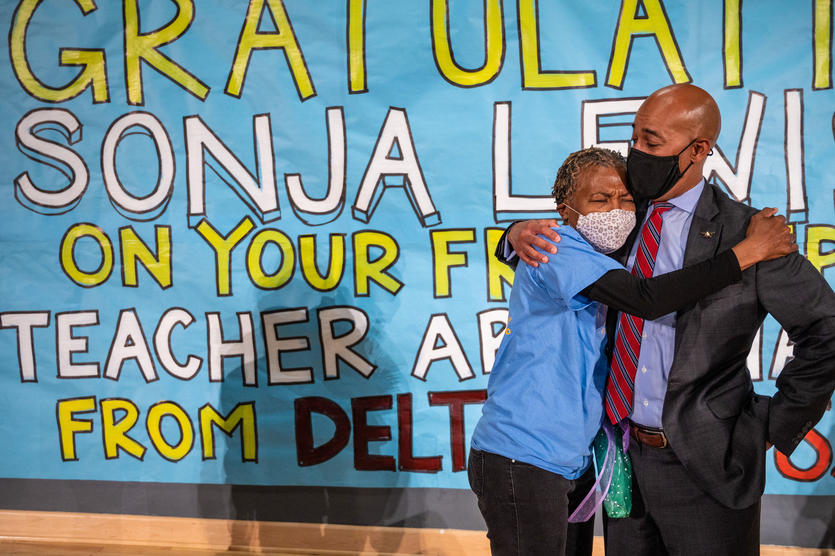 Special education teacher hugs Delta leader after surprised with a vacation