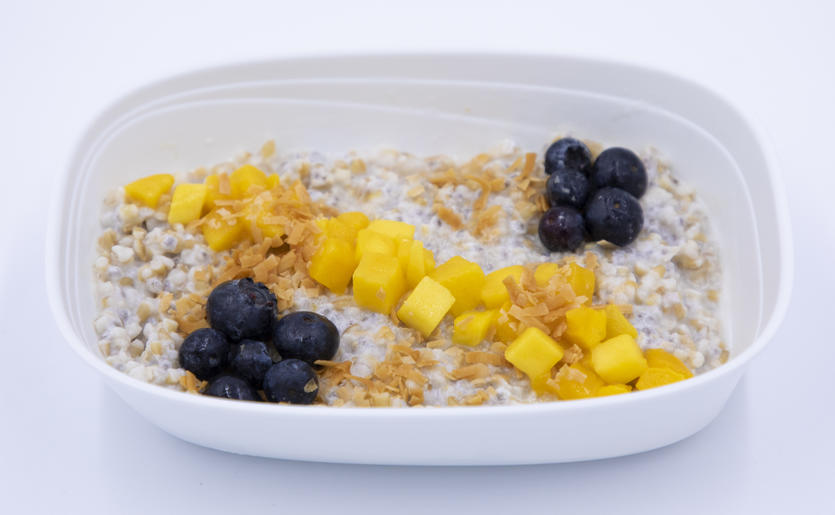Coconut chia oatmeal with mango, blueberries and toasted coconut