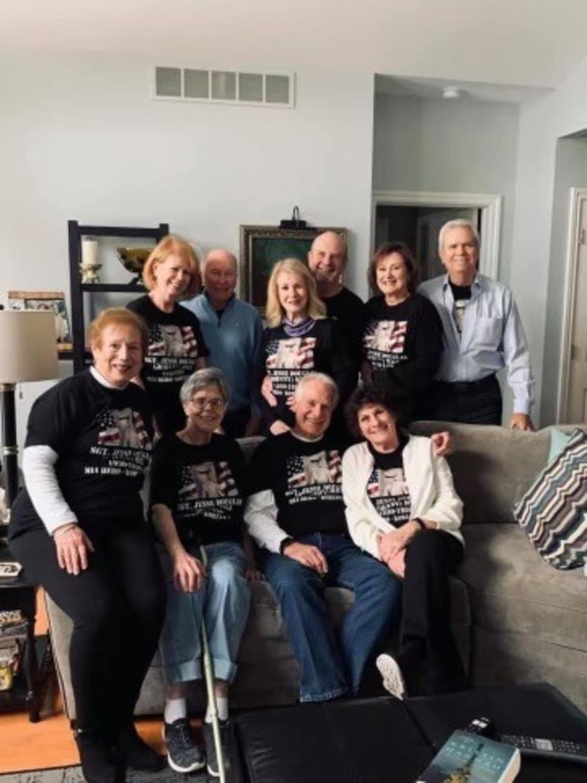 Tom Hill, Tammy’s father, sits center of the couch beside his sisters and proud family of Johnnie. The family created shirts to honor their fallen hero.