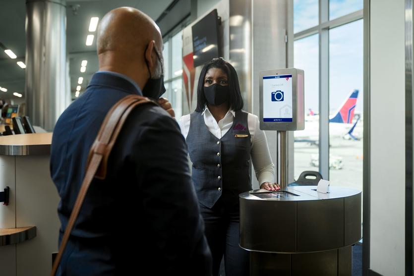A man boards a Delta flight using facial recognition technology.
