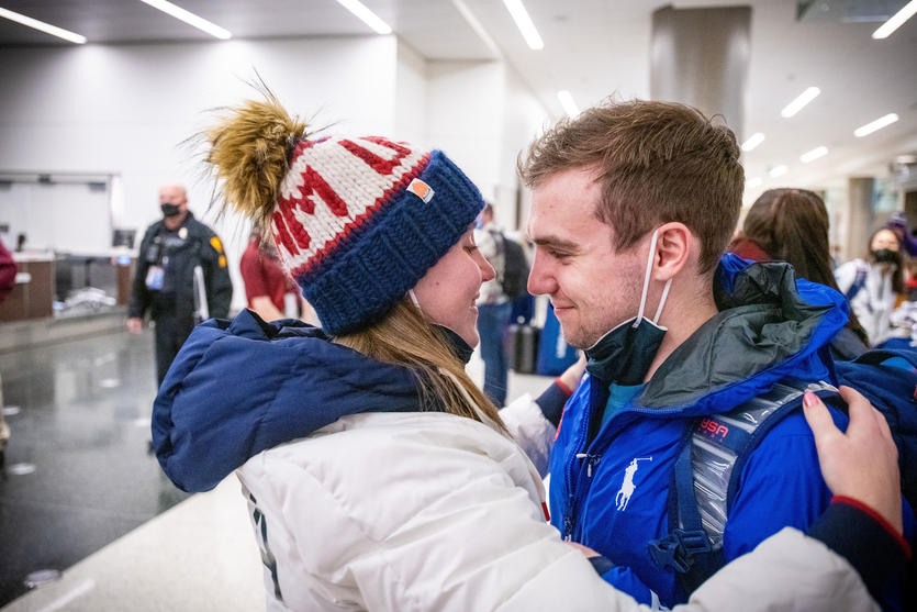 Ryan Pivirotto (right) and his fiancee, Nikki Leonard embrace as Team USA athletes arrive at Salt Lake City International Airport in Salt Lake City, Utah on Monday, February 21, 2022.