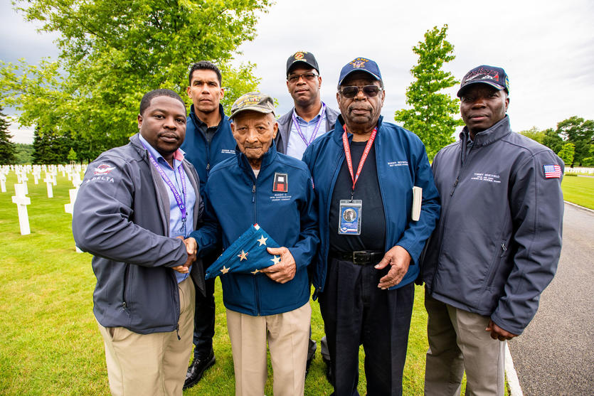 Delta’s Mikail Barnes, Pat Mills and Tommy Whitfield with Donnie Edwards, Buddy Reynolds and Buddy Reynolds Jr. at Brittany American Cemetery. 