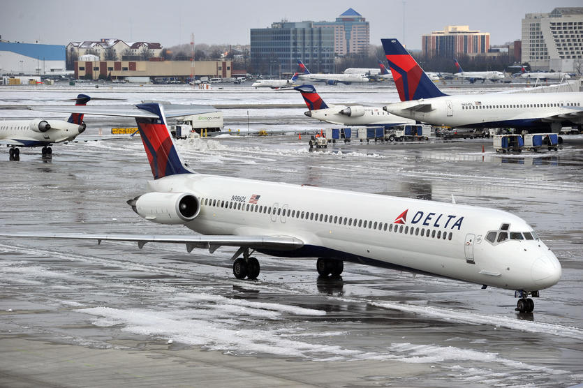 A few aircraft prepare for takeoff on an icy runway.
