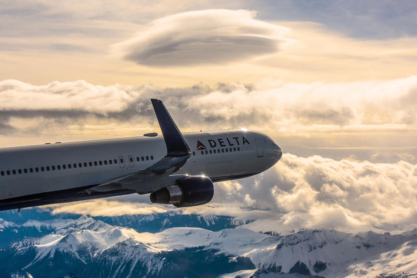 A 767-300 in-flight near the snow capped mountains of Mount Rainier, Seattle.