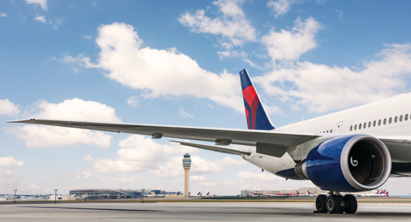A dorsal view of Delta's Boeing 767-400 model sits on the Atlanta-based runway while a dynamic sky overlooks. 
