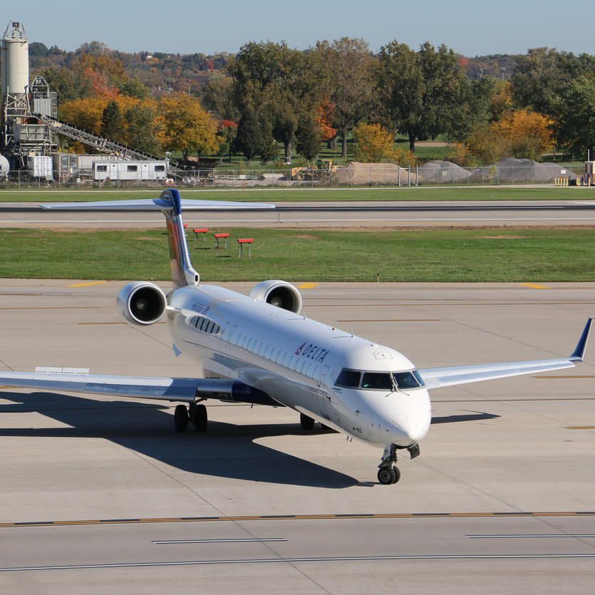 The Delta Bombardier CRJ-900, which seats 70-76 passengers, sits on the runway. 