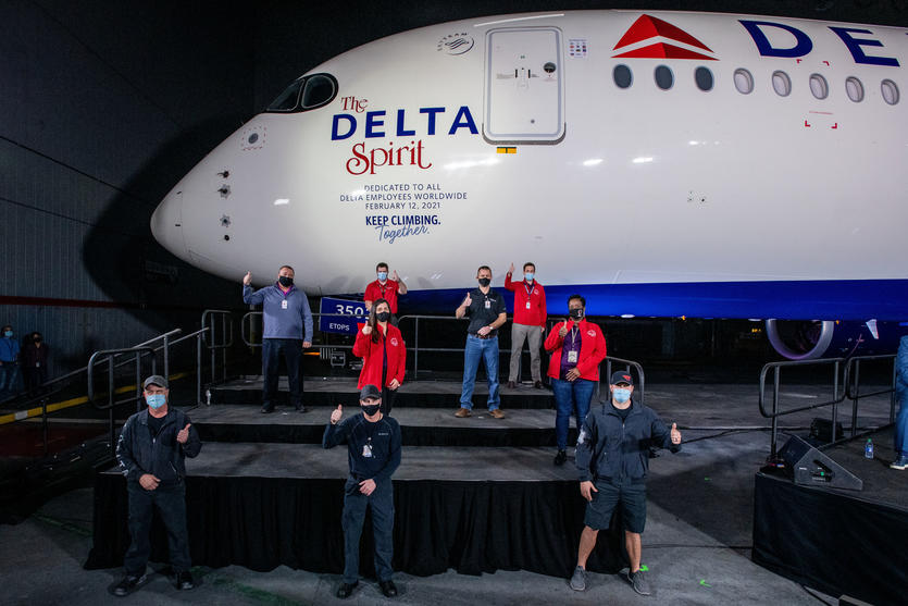 Delta Spirit A350 aircraft inside a hangar with TechOps employees on a stage
