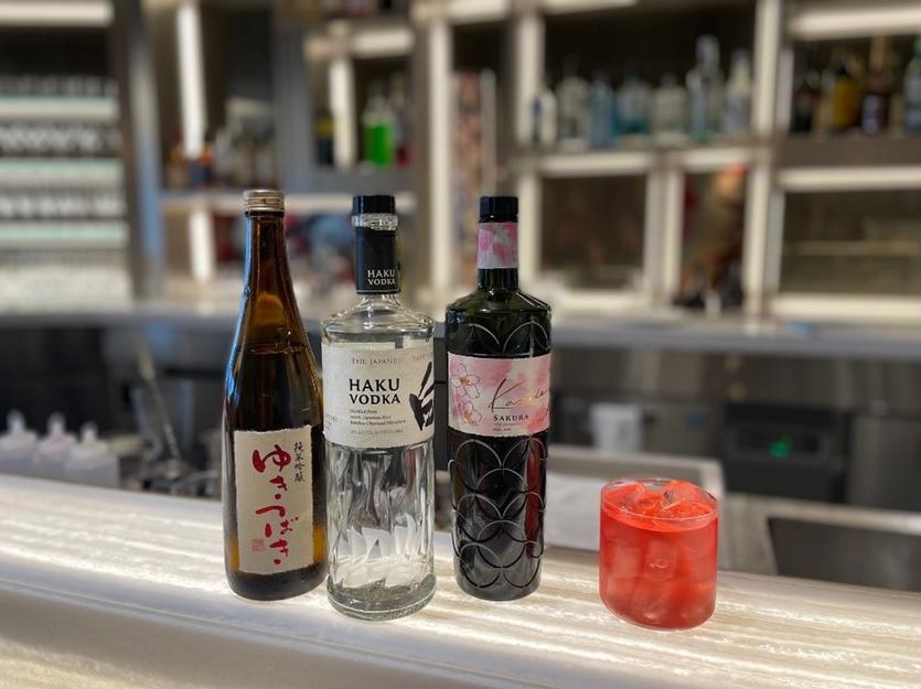 A Sake Blossom Cosmo (right), a cocktail created exclusively for Haneda’s Delta Sky Club.