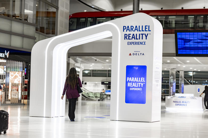 Female customer walking through Parallel Reality Experience archway