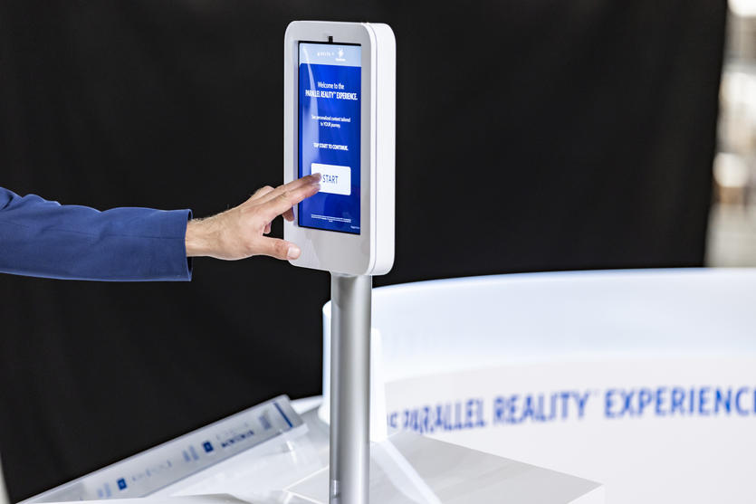 Parallel Reality check-in screen with hand