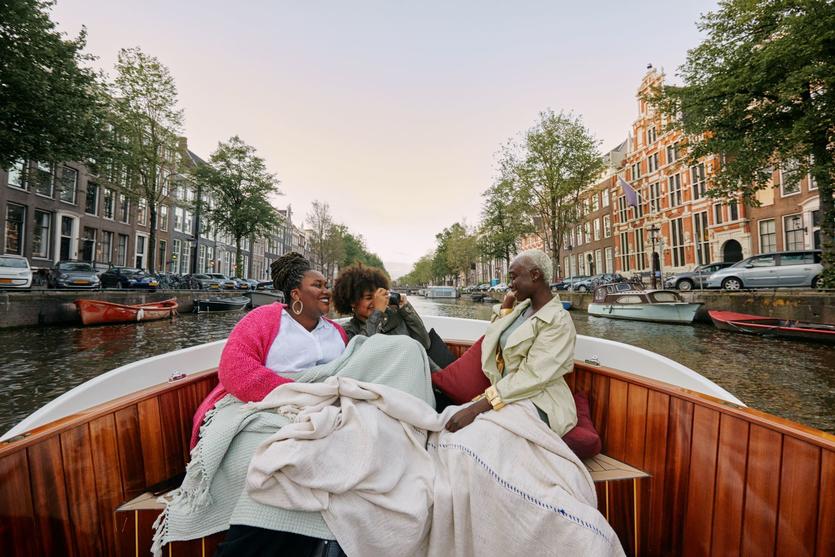 Three women sitting in a boat.