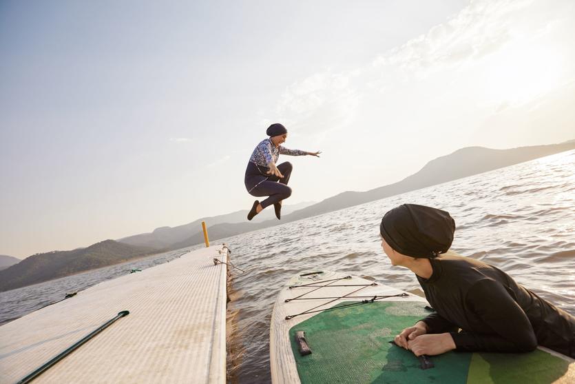 A person jumps into a lake in one of the images available as part of Delta's joint "Faces of Travel" campaign and database.