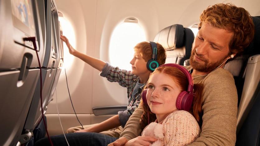 Delta customers enjoying in-flight entertainment