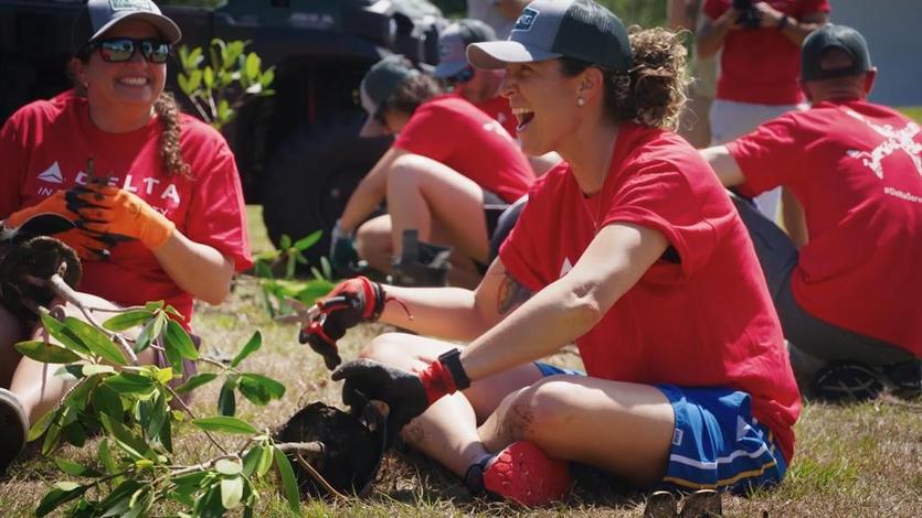 Delta employees participate in a tree planting in 2022.