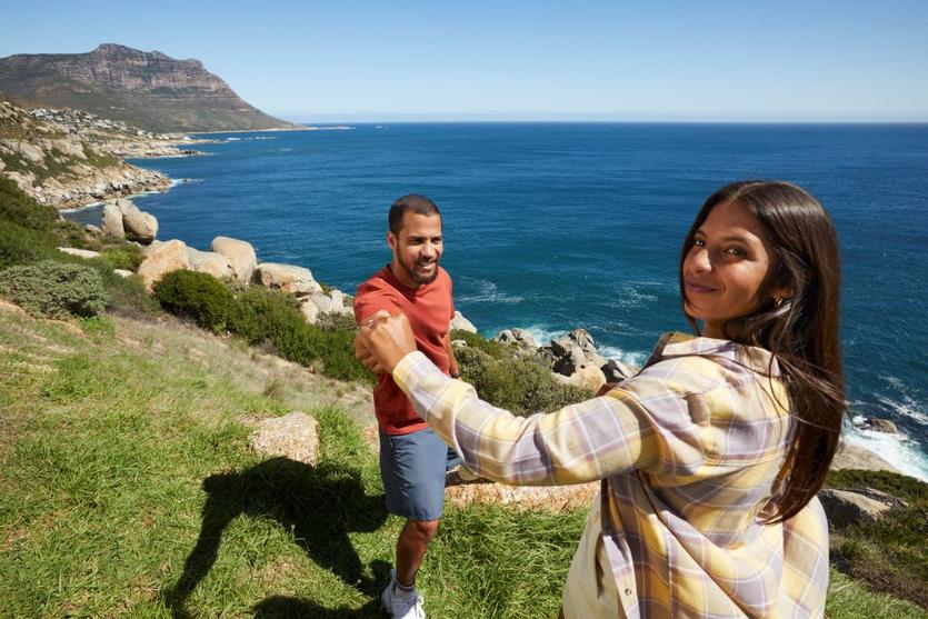 A couple standing in front of Hout Bay in South Africa