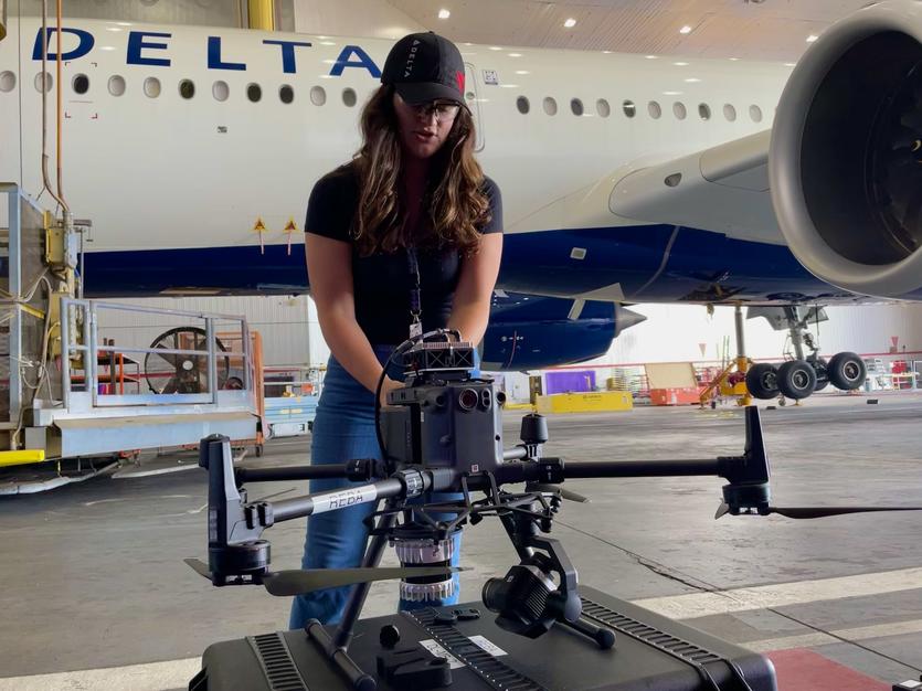 Emma Galarza, a senior engineer with Delta TechOps, prepares an autonomous drone for flight.