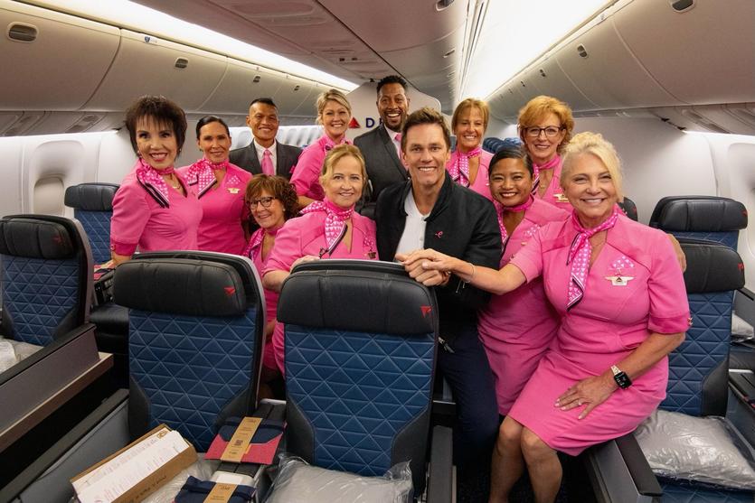 Tom Brady poses with Delta people on board the Breast Cancer One charter flight.