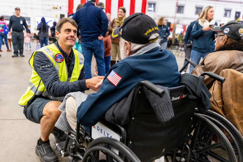 A Delta TechOps employee shakes hands with a U.S. military veteran at Delta's 12th annual Veterans Celebration.