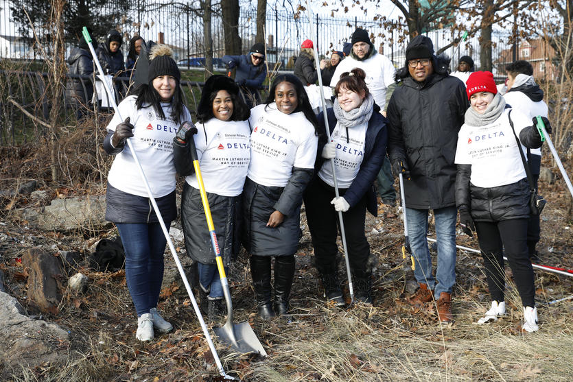 Queens Borough President Donovan Richards joins Delta people in clean up event at Flushing Meadows Park on MLK Day.