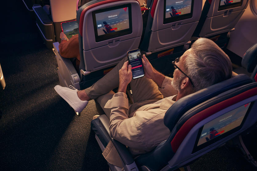 A Delta customer connects to free Wi-Fi while seated in Delta Comfort+.