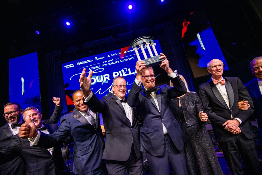 A group shot, with CEO Ed Bastian holding up his Four Pillar Award